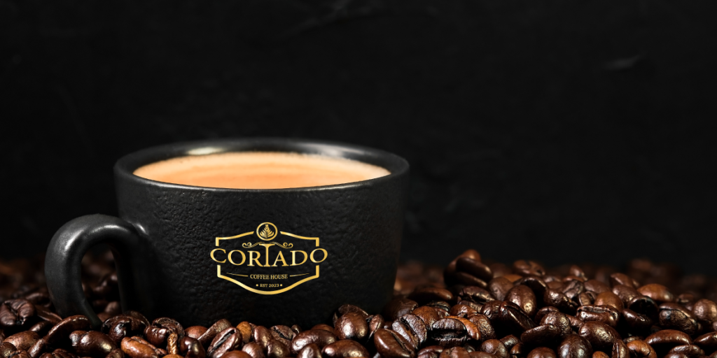 The cortado being poured at Cortado Coffee House Madaba — espresso meets steamed milk in a clear glass
